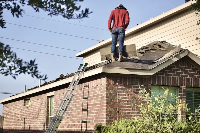 Professional roofer working on a residential roof in Creston-Kenilworth
